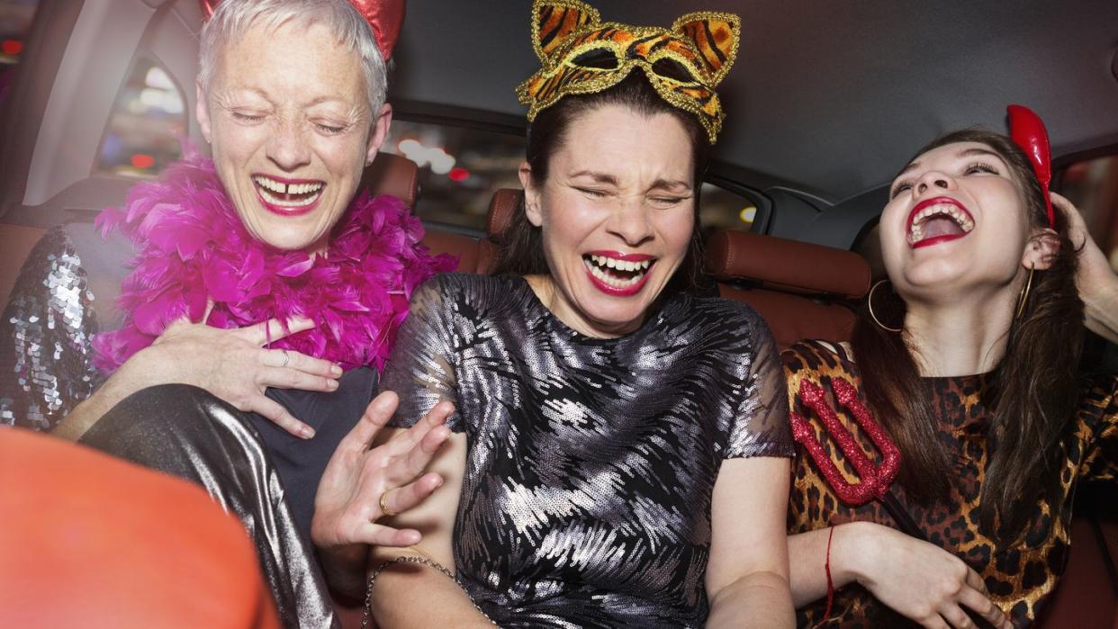 senior women and daughter laughing in car