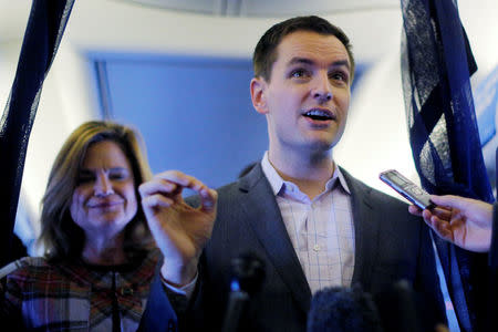 Robby Mook, Campaign Manager for U.S. Democratic presidential nominee Hillary Clinton, and Communications Director Jen Palmieri (L) talk to reporters onboard the campaign plane enroute to Cedar Rapids, Iowa, U.S. October 28, 2016. REUTERS/Brian Snyder