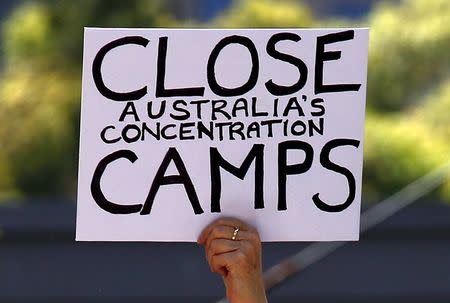 A protester holds a placard during a rally in support of refugees in central Sydney, Australia, October 19, 2015. REUTERS/David Gray/File photo