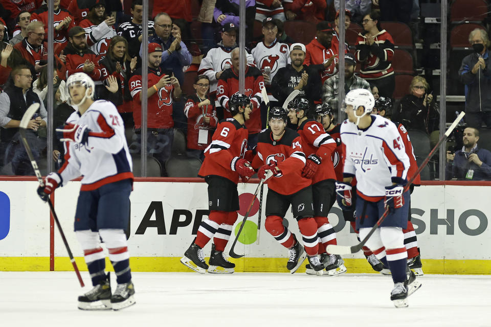 New Jersey Devils right wing Nathan Bastian (14) celebrates with teammates after scoring a goal in the first period of an NHL hockey game against the Washington Capitals, Monday, Oct. 24, 2022, in Newark, N.J. (AP Photo/Adam Hunger)