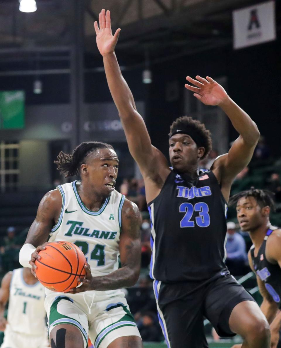 Tulane forward Kevin Cross (24) gets past Memphis center Malcolm Dandridge (23) for a shot during the first half of an NCAA college basketball game in New Orleans, Wednesday, Dec. 29, 2021.