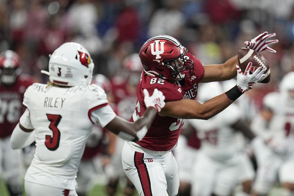 Indiana's Bradley Archer (82) makes a catch against Louisville defensive back Quincy Riley during the second half of an NCAA college football game, Saturday, Sept. 16, 2023, in Indianapolis. (AP Photo/Darron Cummings)
