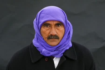 A Kurdish man poses for a picture as he arrives for a gathering celebrating Newroz in Diyarbakir March 21, 2015. REUTERS/Umit Bektas