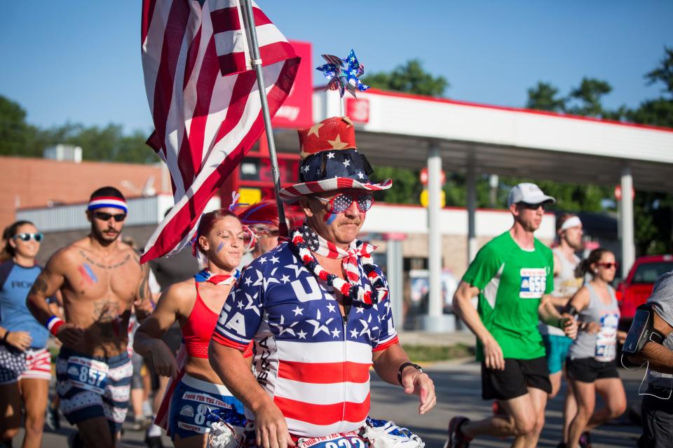 Runners take to the streets on July 4 during the annual Four for the Fourth race in downtown Yorktown. The annual race helps raise money for trails in Yorktown. 