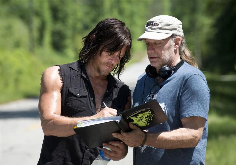 "Walking Dead" actor Norman Reedus (left) is seen on the set of the popular television show with Greg Nicotero, a special effect makeup artist and producer/director.