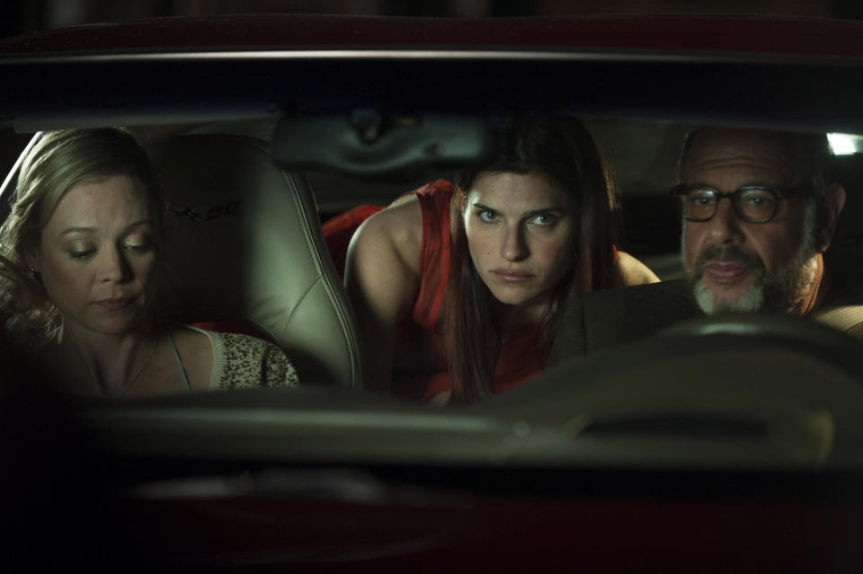 This publicity photo released by Roadside Attractions shows, from left, Alexandra Holden, Lake Bell and Fred Melamed, in a scene from the film "In a World...," a comedy about a struggling voice coach. Written and directed by Bell, who also stars in the film, it won the Sundance 2013 Waldo Salt Screenwriting Award for the script. Real voice-over artists, the men and women who’ve spent years invisibly announcing the latest Taco Bell temptation, the promise of Firestone tires or upcoming Lifetime programs, who’ve seen the film (which expands to more than 30 locations Aug. 16, 2013) say it’s great to watch their profession on screen. (AP Photo/Roadside Attractions, Bonnie Osborne)