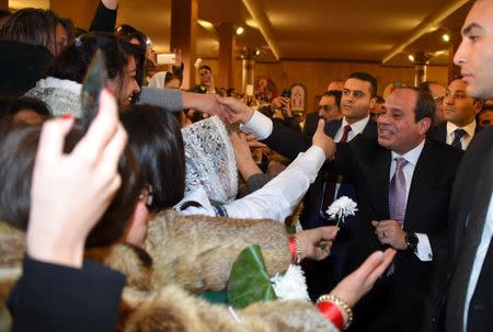 Egyptian President Abdel Fattah al-Sisi (R) greets faithful at the new Coptic Cathedral "The Nativity of Christ" in the new administrative capital, 45km east of Cairo, Egypt, January 6, 2018 in this handout picture courtesy of the Egyptian Presidency. The Egyptian Presidency/Handout via REUTERS