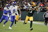 Green Bay Packers' Davante Adams catches a long pass in front of Los Angeles Rams' Jalen Ramsey during the first half of an NFL football game Sunday, Nov. 28, 2021, in Green Bay, Wis. (AP Photo/Morry Gash)