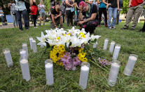 <p>Counter protesters pay their respects at a vigil where 20 candles were burned for the 19 people injured and one killed when a car plowed into a crowd of counter protesters at the “Unite the Right” rally organized by white nationalists in Charlottesville, Virginia, U.S., August 12, 2017. (Jim Bourg/Reuters) </p>