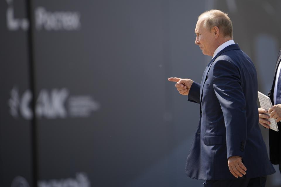 Putin walks to inspect a prototype of Russia's prospective fighter jet at the MAKS-2021 International Aviation and Space Salon in Zhukovsky outside Zhukovsky, Russia, Tuesday, July 20, 2021. Russia on Tuesday unveiled a prototype of its prospective new fighter jet at the Moscow air show. (AP Photo/Alexander Zemlianichenko, Pool)