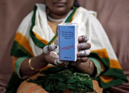A patient displays a bottle of medicine at an office of HIV/AIDS activists in New Delhi in this file photo dated October 13, 2014. REUTERS/Anindito Mukherjee