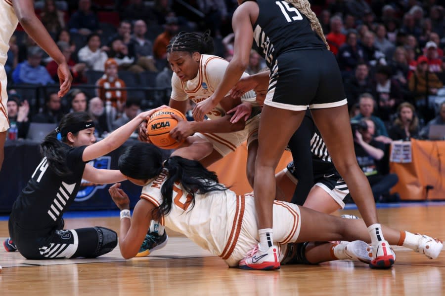 Texas forward Madison Booker, top center, goes for the ball against Gonzaga guard Kaylynne Truong, bottom left, and others during the first half of a Sweet 16 college basketball game in the women’s NCAA Tournament, Friday, March 29, 2024, in Portland, Ore. (AP Photo/Howard Lao)