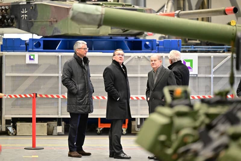 German Chancellor Olaf Scholz (2nd R) and Boris Pistorius (2nd L), German Minister of Defense, inspect a production hall with armoured vehicles from the Rheinmetall armaments group. Chancellor Scholz attends a symbolic ground-breaking ceremony to mark the start of construction of a new Rheinmetall ammunition factory. The ammunition factory will produce artillery ammunition, explosives and rocket artillery. Philipp Schulze/dpa