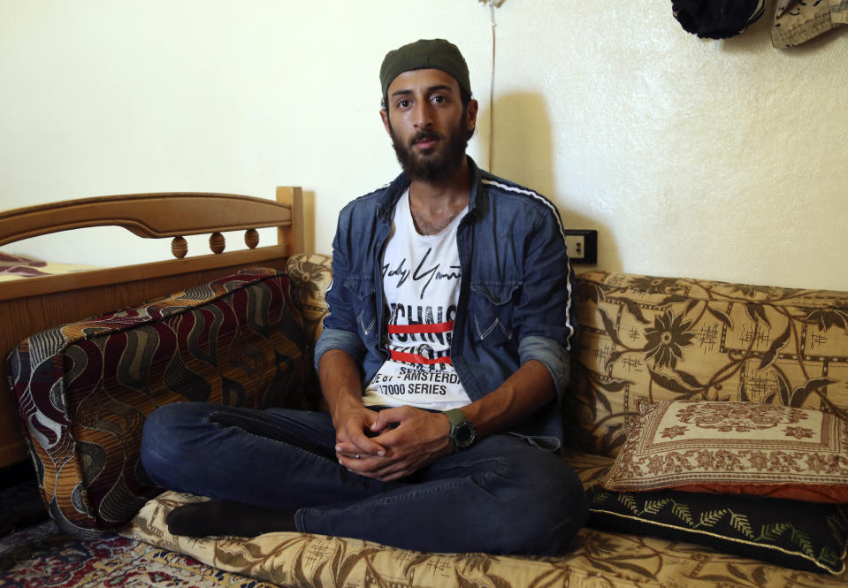 In this photo taken on Aug. 10, 2019, Abdullah Abdullkader, 27, from Aleppo, poses for the photographer, in Afrin, Syria. Abdullkader, who worked at a laundry in the southern city of Gaziantep in Turkey, was with two Syrian friends heading to get dinner when police asked for their IDs. When he told the officer he did not have it, he was slapped, handcuffed and detained and later deported back to Syria. Syrians say Turkey has been detaining and forcing some Syrian refugees to return back to their country the past month. The expulsions reflect increasing anti-refugee sentiment in Turkey, which opened its doors to millions of Syrians fleeing their country's civil war. (AP Photo)