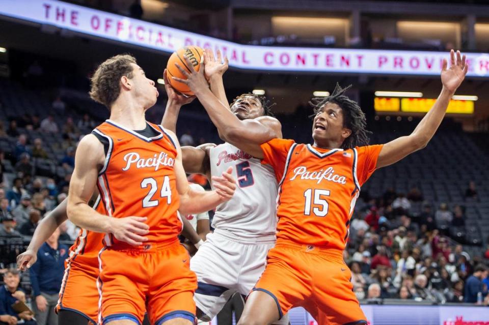 San Joaquin Memorial forward Mike Davis Jr. (5) draws a foul on Pacifica Christian Tritons Jeffry Bohlinger (15) and makes one of the free throws in the first half in the CIF State Division II Boys Basketball Championships on Saturday, March 11, 2023, at Golden 1 Center in Sacramento. Sara Nevis/snevis@sacbee.com