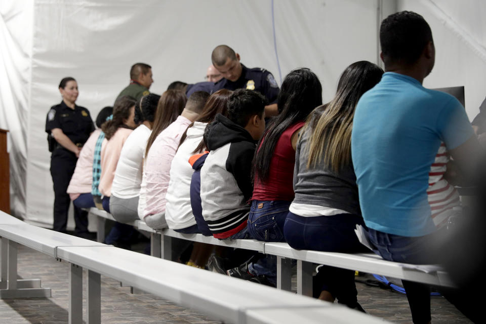 Migrants who are applying for asylum in the United States go through a processing area at a new tent courtroom at the Migration Protection Protocols Immigration Hearing Facility on Sept. 17, 2019, in Laredo, Texas. (Eric Gay / AP file)