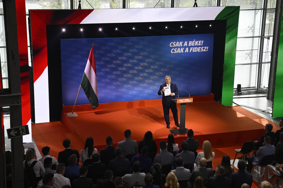 Hungarian Prime Minister and Chairman of Fidesz party Viktor Orban addresses a rally launching the campaign of the party for the European Parliamentary and the local elections in Budapest, Hungary, Friday, April 19, 2024. The inscription reads The peace only! The Fidesz only! Hungarian Prime Minister Viktor Orbán on Friday painted a grim picture of a continent teetering on the edge of armed conflict in a speech opening his party's campaign for European Union elections. He called for a changing of the guard among the bloc's leaders. (Szilard Koszticsak/MTI via AP)