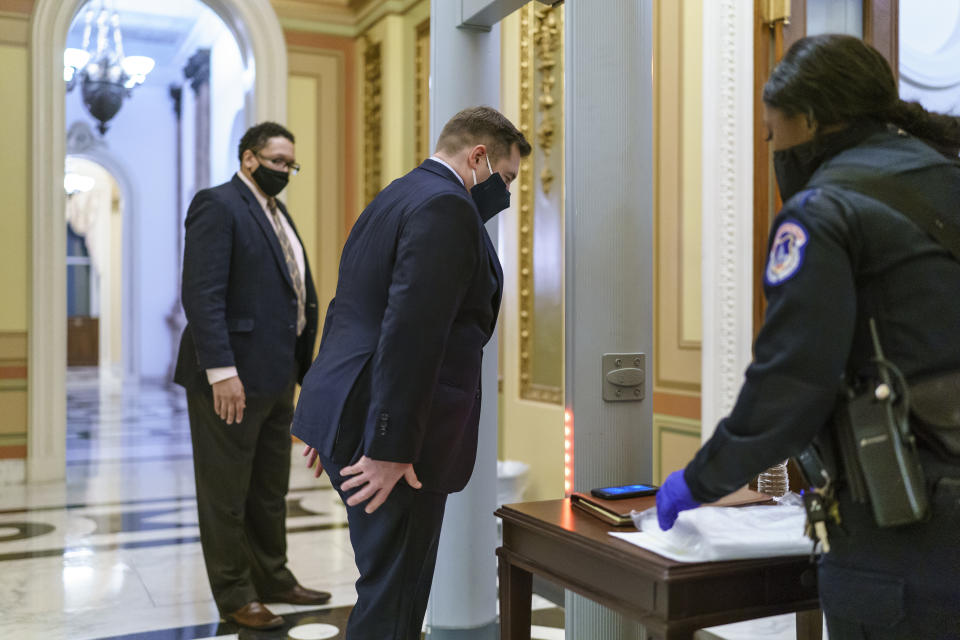 New member Rep. Guy Reschenthaler, R-Pa., passes through a metal detector before entering the House chamber, a new security measure put into place after a mob loyal to President Donald Trump stormed the Capitol, in Washington, Tuesday, Jan. 12, 2021. The House is trying to push the vice president and Cabinet to act even more quickly to remove President Donald Trump from office, with Democrats set to pass a resolution calling on Vice President Mike Pence to invoke constitutional authority under the 25th Amendment to oust Trump. (AP Photo/J. Scott Applewhite)