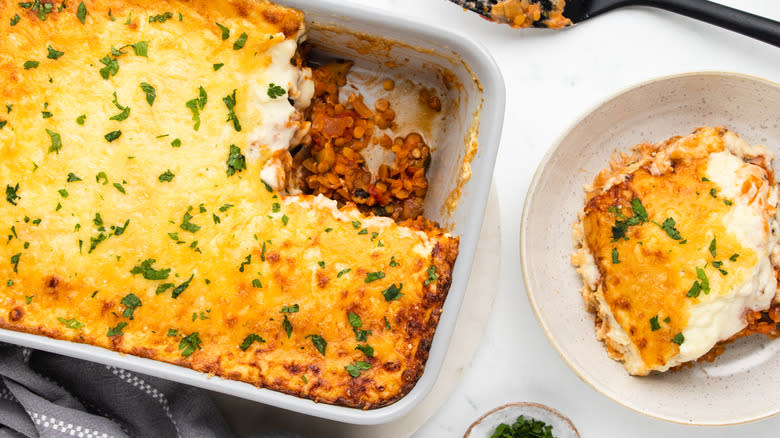 Lentil moussaka in baking dish and bowl