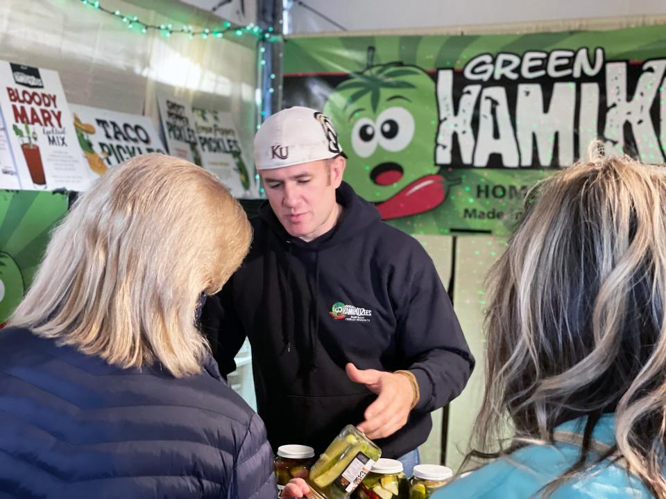 Green Kamikozees owner Jeremiah Kozlowski interacts with patrons at Christkindlmarkt in Bethlehem. The brand is TikTok famous for their ghost pepper pickles.