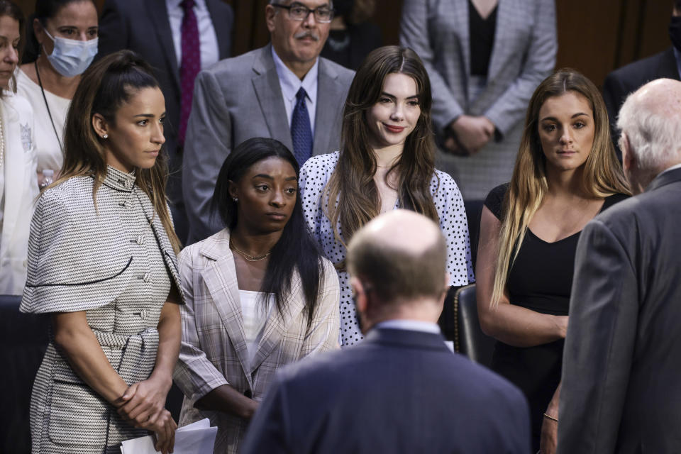 WASHINGTON, DC - SEPTEMBER 15: (L-R)  U.S. Olympic Gymnasts Aly Raisman, Simone Biles, McKayla Maroney and NCAA and world champion gymnast Maggie Nichols are approached by Sen. Pat Leahy (D-VT) after their testimony during a Senate Judiciary hearing about the Inspector General's report on the FBI handling of the Larry Nassar investigation of sexual abuse of Olympic gymnasts, on Capitol Hill on September 15, 2021 in Washington, DC. Biles and other fellow U.S. Gymnasts gave testimony on the abuse they experienced at the hand of Larry Nassar, the former US women's national gymnastics team doctor, and the FBI’s lack of urgency when handling their cases. (Photo by Anna Moneymaker/Getty Images)