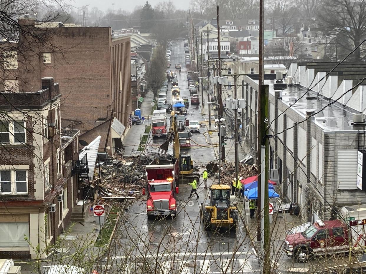 Emergency responders and heavy equipment are seen at the site of a deadly explosion at a chocolate factory in West Reading, Pennsylvania, Saturday, March 25. / Credit: Michael Rubinkam / AP