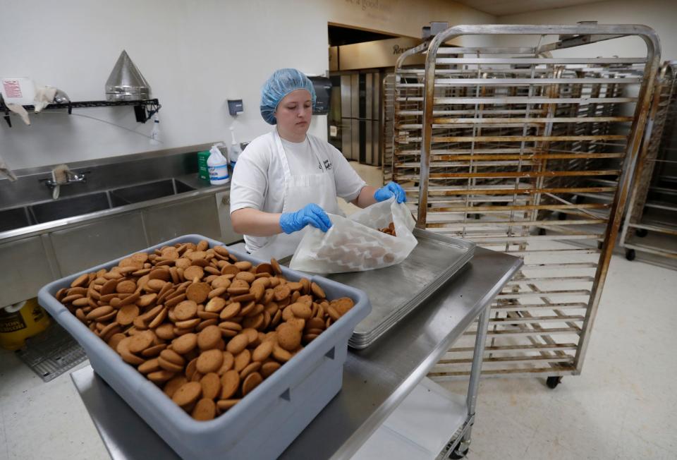 Less Cook gets Vanilla Wafers ready for packaging at the Slaton Bakery in Slaton on June 24, 2021.