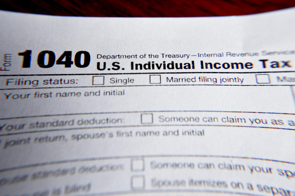 FILE - This Wednesday, Feb. 13, 2019 file photo shows part of a 1040 federal tax form printed from the Internal Revenue Service website. On Friday, Aug. 21, 2020, The Associated Press reported on stories circulating online incorrectly asserting that Democratic presidential candidate Joe Biden’s tax rate on a family making $75,000 dollars a year would go from 12% to 25%. A current federal tax rate of 12% applies to families making up to $80,000, or individuals making up to $40,000. That would still apply under Biden, who has vowed publicly not to raise taxes on anyone making less than $400,000.