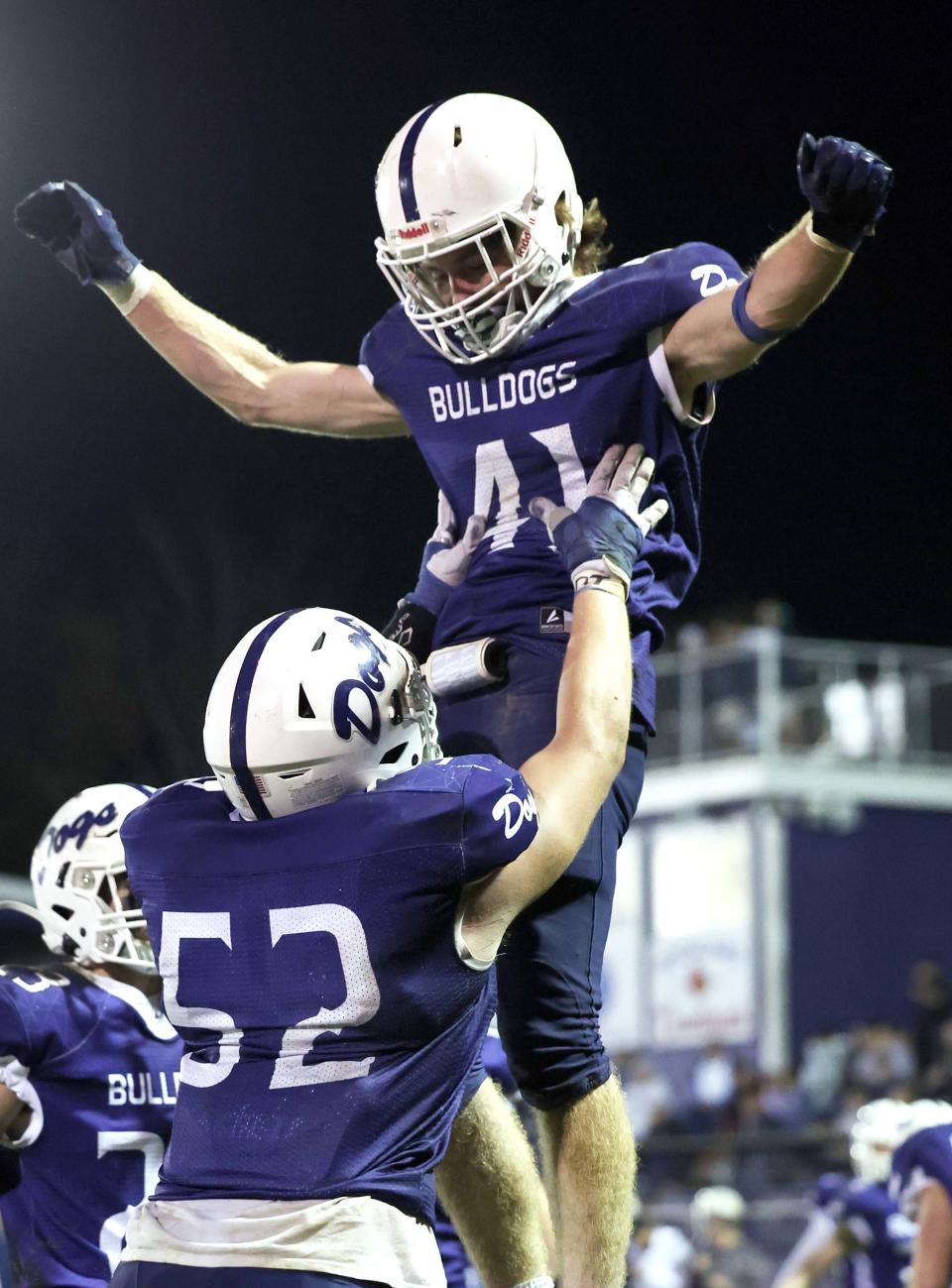 Rockland running back Jacob Coulstring carries the football for a touchdown and is hoisted into the air by Leary Costa during a game versus Seekonk on Friday, Nov. 4, 2022.