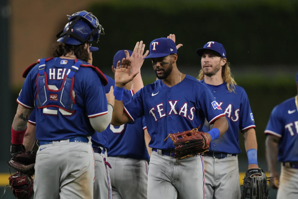 Texas Rangers center fielder Leody Taveras and left fielder Travis Jankowski greet the team after their 10-6 win over the Detroit Tigers in a baseball game, Tuesday, May 30, 2023, in Detroit. (AP Photo/Carlos Osorio)