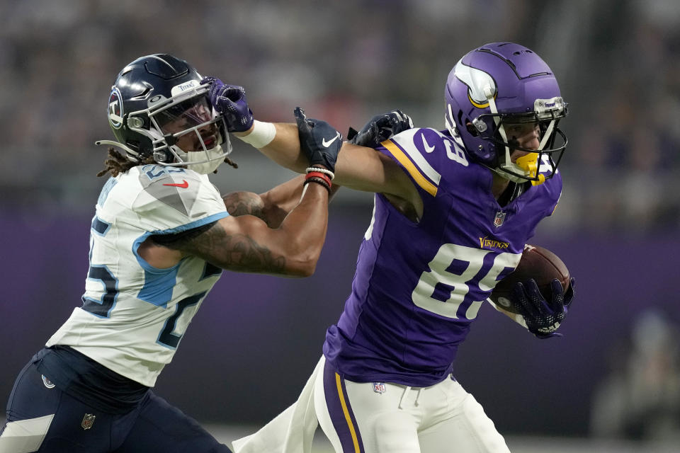 Minnesota Vikings wide receiver Thayer Thomas (89) fights off a tackle attempt by Tennessee Titans cornerback Armani Marsh (25) as Thomas gains yards after a catch in the first half of a preseason NFL football game, Saturday, Aug. 19, 2023, in Minneapolis. (AP Photo/Charlie Neibergall)