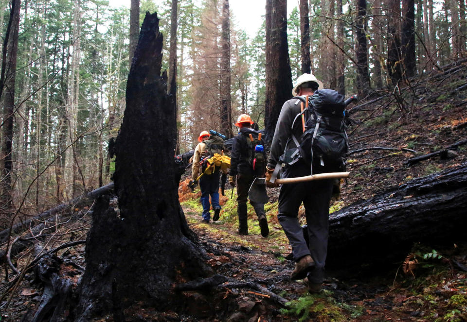 Trail crew members hiking (Jamie Hale/The Oregonian via AP file)