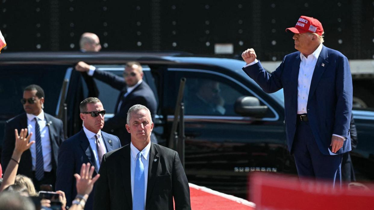 PHOTO: Members of the US Secret Service look on as former President and Republican presidential candidate Donald Trump arrives to speak during a campaign rally at the Aero Center in Wilmington, N.C., Sept. 21, 2024. (Jim Watson/AFP via Getty Images)