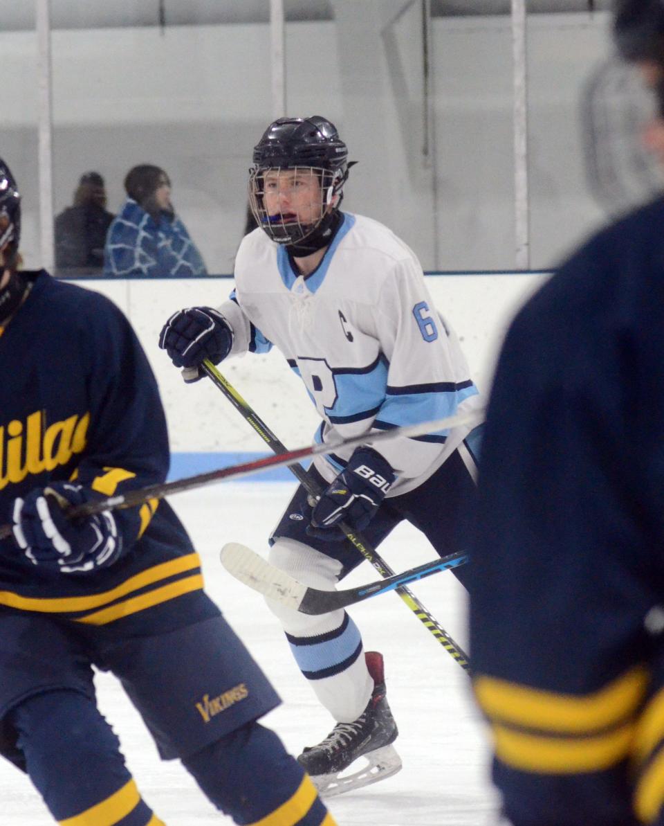 Petoskey's Dylan Robinson watches a teammate with the puck, staying ready and open for the pass.