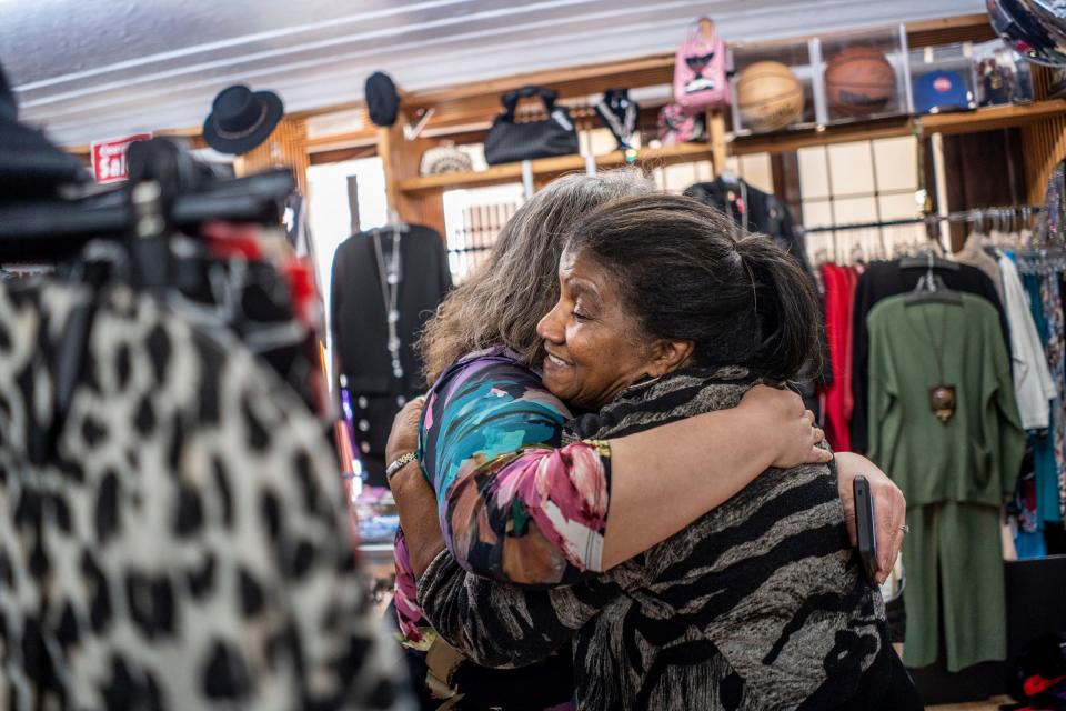 The Fashion Place co-owner Jean Jarrett, right, hugs The Peacock Room proprietress Rachel Lutz as she visits Jarrett's store in the Fisher Building in Detroit on Wednesday, November 29, 2023.