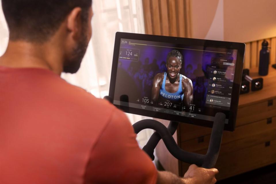 A person riding a Peloton fitness machine. Source: Peloton. Hyatt Hotels