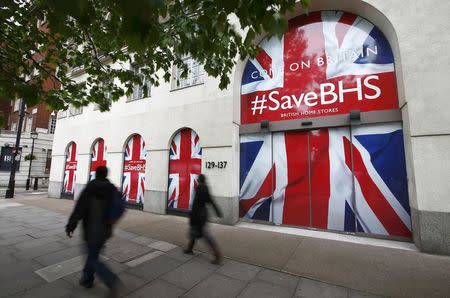 People walk past the headquarters of retailer British Home Stores after it was announced that BHS is to be wound down after administrators failed to find a buyer for the 88-year-old retailer, in central London, Britain June 2, 2016. REUTERS/Peter Nicholls