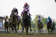 Jose Ortiz, center, atop Early Voting, edges out Joel Rosario, center left, atop Epicenter, to win during the 147th running of the Preakness Stakes horse race at Pimlico Race Course, Saturday, May 21, 2022, in Baltimore. (AP Photo/Julio Cortez)