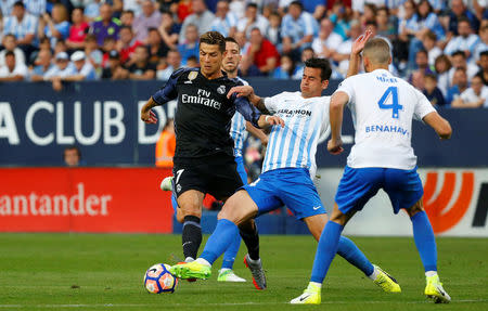 Football Soccer - Malaga v Real Madrid - Spanish Liga Santander - La Rosaleda, Malaga, Spain - 21/5/17 Real Madrid’s Cristiano Ronaldo in action with Malaga's Luis HernandezReuters / Juan Medina