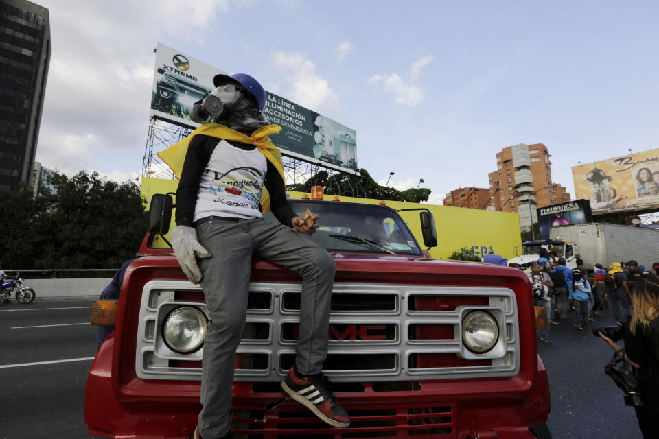 A demonstrator take control of a truck to block a highway after a demonstration demanding the resignation of President Nicolas Maduro, in Caracas, Venezuela, Saturday, Feb. 2, 2019. Momentum is growing for Venezuela's opposition movement led by Guaido, who has called supporters back into the streets for nationwide protests Saturday, escalating pressure on Maduro to step down.(AP Photo/Fernando Llano)