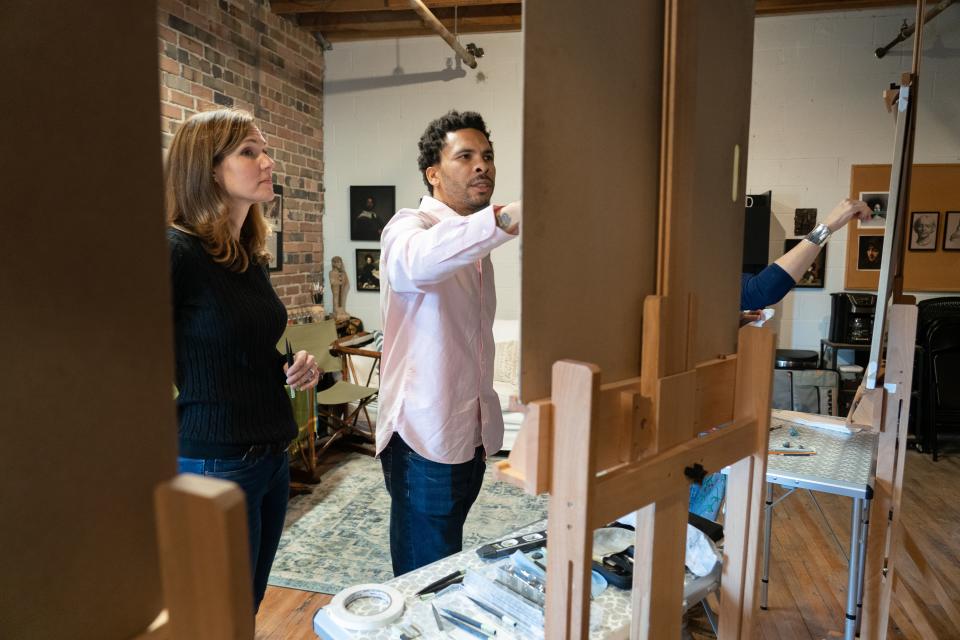 George Morton helps Jen Stallone Riddell with a figure drawing in his class.