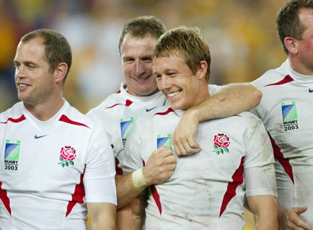 Jonny Wilkinson (centre right) is congratulated by team-mate Mike Catt after his drop goal clinched the 2003 Rugby World Cup 