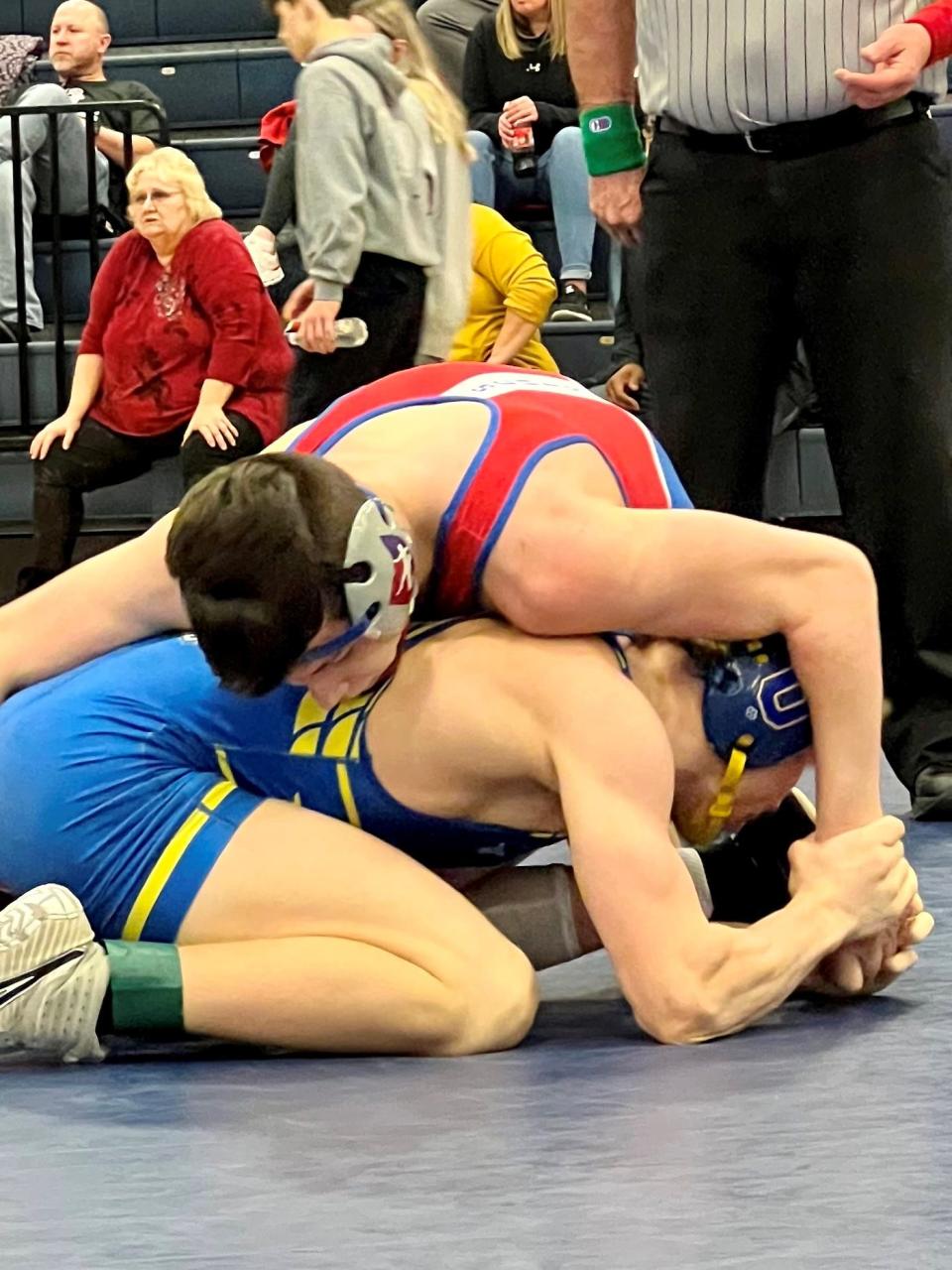 Highland's Cael Gilmore, top, ties up Ontario's Mason Turnbaugh in the 150-pound championship match at the Mid Ohio Athletic Conference Wrestling Tournament Saturday at Galion.