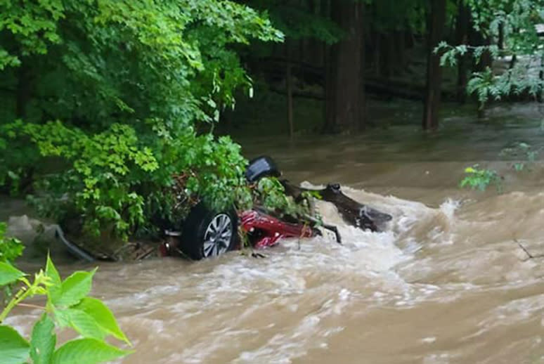 An overturned vehicle in floodwaters in Port Jervis, N.Y., on Sunday. (Port Jervis Fire Dept.)