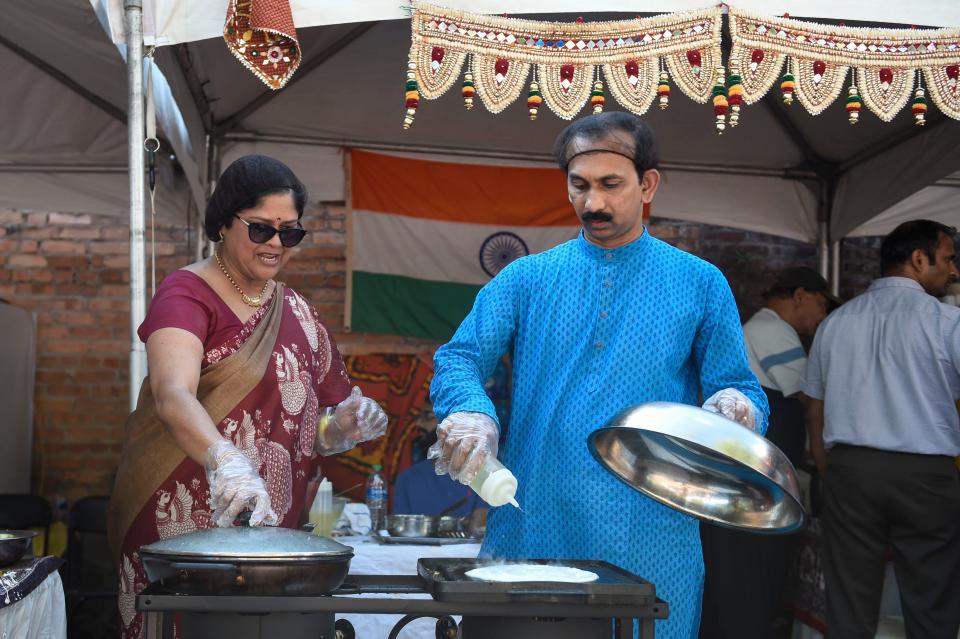 Food is prepared at the India tent during Arts in the Heart on Saturday, Sept. 17, 2022. Attendees can eat food from around the world, browse for art, and watch live performances. The festival continues through Sunday. 