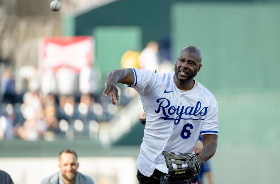 Former Kansas City Royals center fielder Lorenzo Cain throws the ceremonial first pitch to former teammate Salvador Perez during a retirement ceremony at Kauffman Stadium on Saturday, May 6, 2023, in Kansas City. Cain signed a ceremonial one-day contract to retire as a Royal.