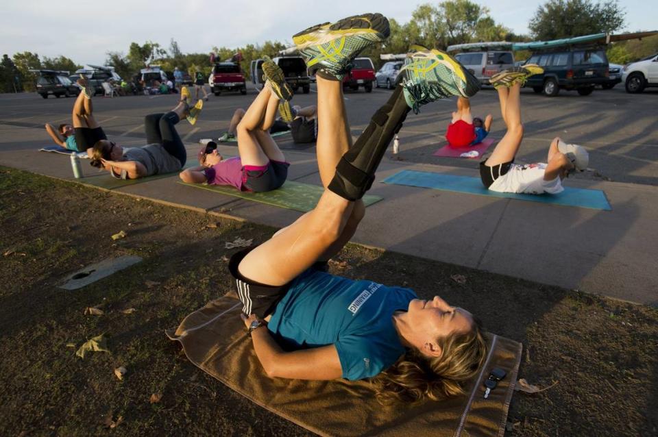 World champion paracyclist Jamie Whitmore leads core exercises with a group of triathletes she was training at Lake Natoma in 2014, the year she was awarded an ESPN ESPY for Best Female Athlete with a Disability.