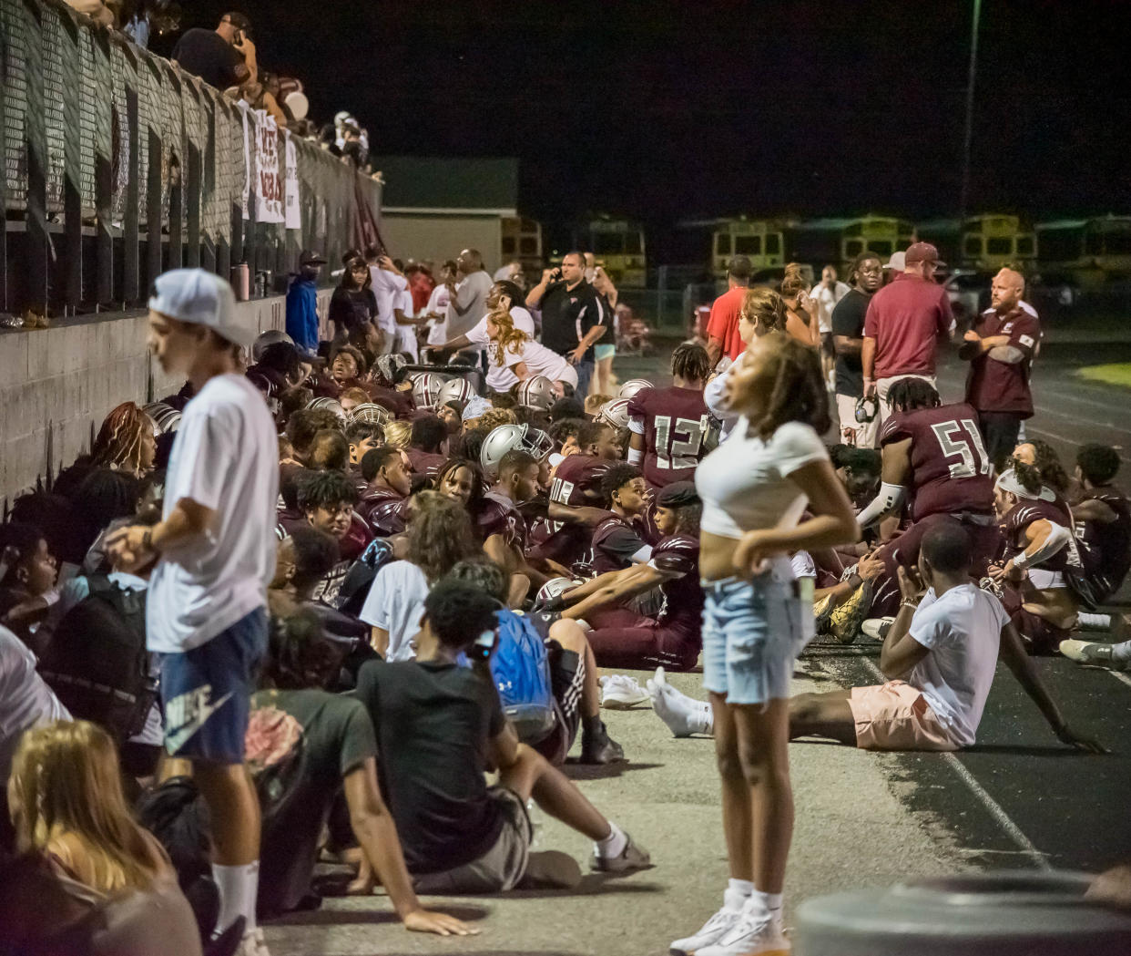 Students, staff, and family members take shelter along with West Creek's football team after shots were fired outside West Creek's football stadium during a game against Northeast Friday, Aug. 19, 2022 in Clarksville.