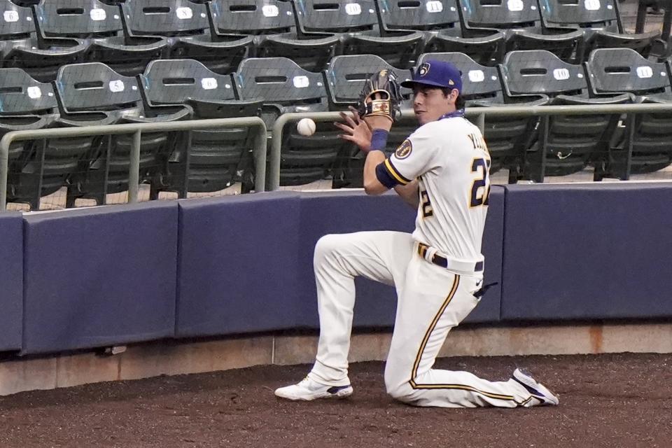 Milwaukee Brewers' Christian Yelich can't catch a foul ball hit by Minnesota Twins' Jorge Polanco during the third inning of a baseball game Monday, Aug. 10, 2020, in Milwaukee. (AP Photo/Morry Gash)