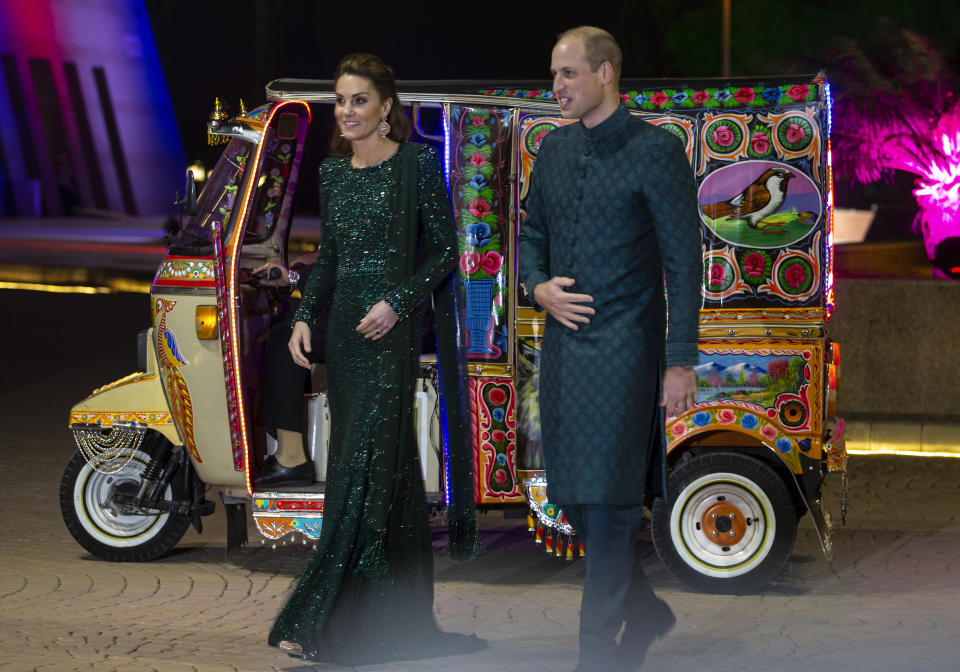 Britain's Prince William and his wife Kate arrive in a traditionally painted motorized rickshaw to attend a reception in Islamabad, Pakistan, Tuesday, Oct. 15, 2019. They kicked off a five-day tour of Pakistan on Tuesday amid much fanfare and tight security. (AP Photo/B.K. Bangash)